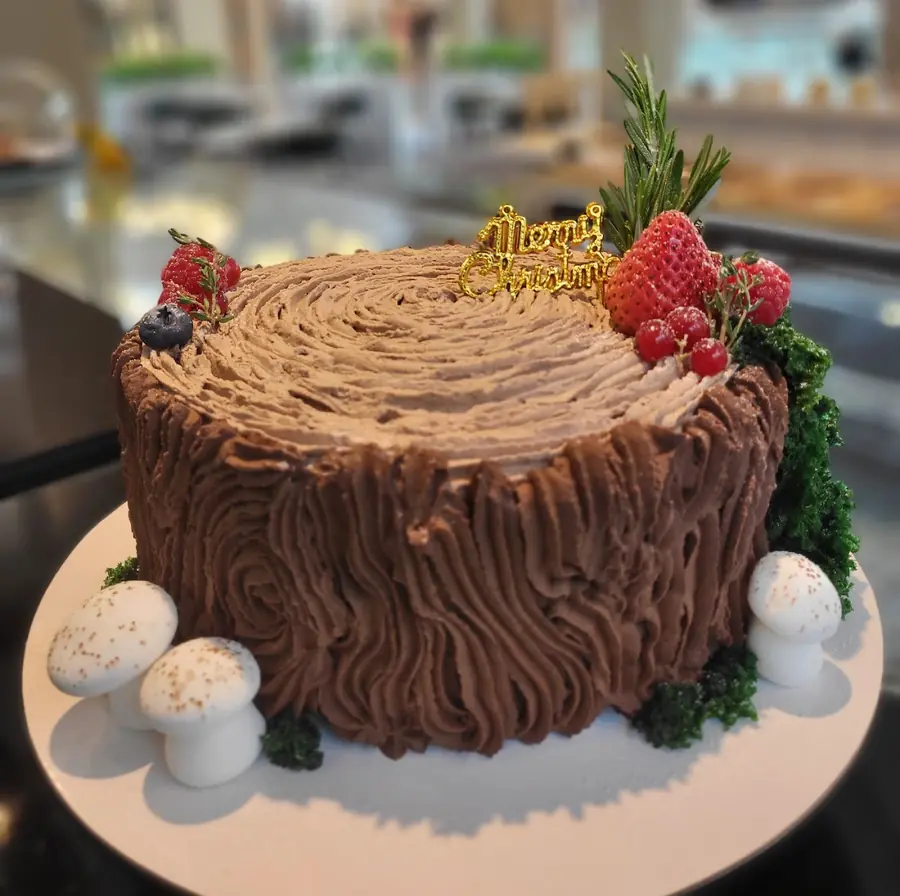 Chocolate log cake with berries by Deli Bonbons
